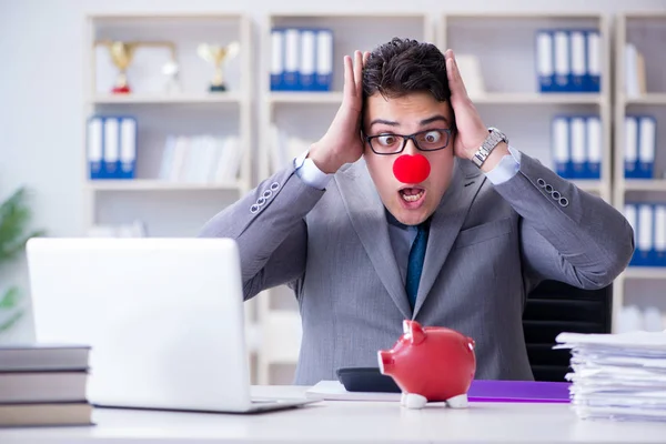 Clown businessman with piggy bank doing accounting