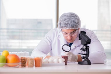 Besin uzmanı gıda ürünlerini laboratuarda test ediyor.