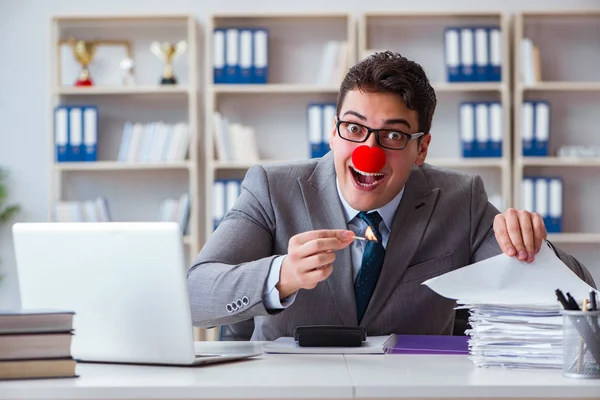 Clown businessman burning paper papers in the office — Stock Photo, Image