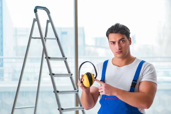 Worker with noise cancelling headphones