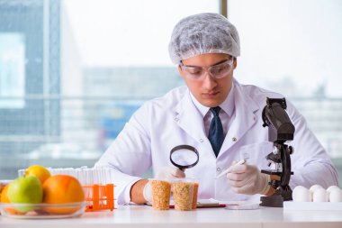 Besin uzmanı gıda ürünlerini laboratuarda test ediyor.