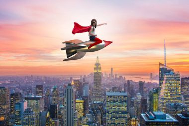 Süper kahraman kavramında küçük bir kız roket uçuruyor.