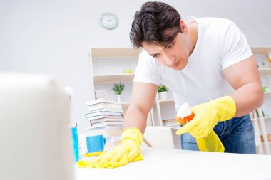 Adam evi temizliyor.