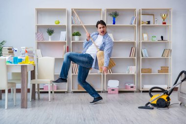 Adam evi temizliyor.