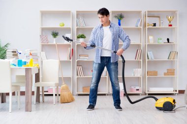 Adam evi temizliyor.