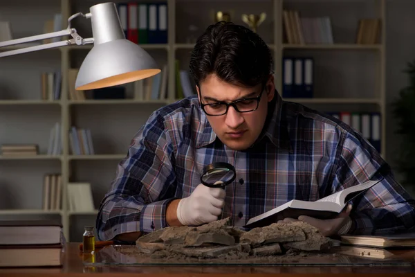 Archeologist working late night in office — Stock Photo, Image