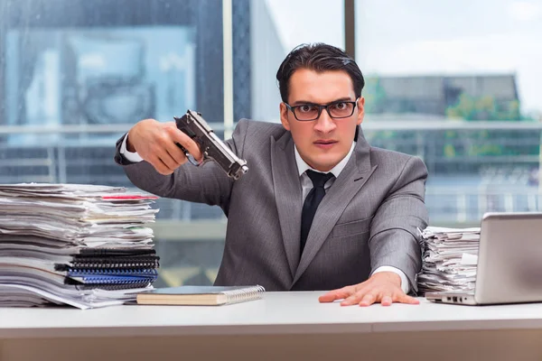 Angry businessman with gun in the office — Stock Photo, Image