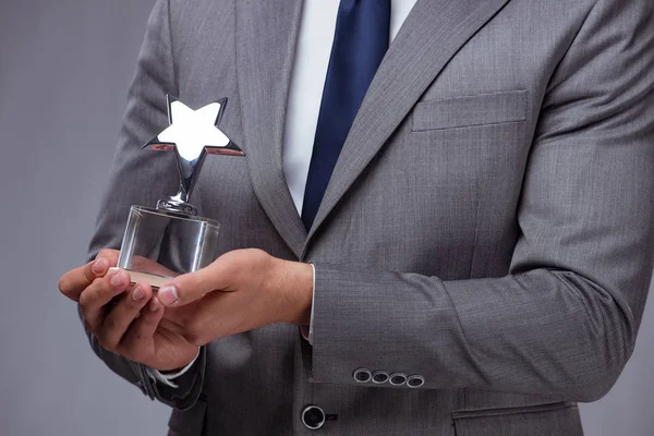 Businessman holding star award in business concept — Stock Photo, Image