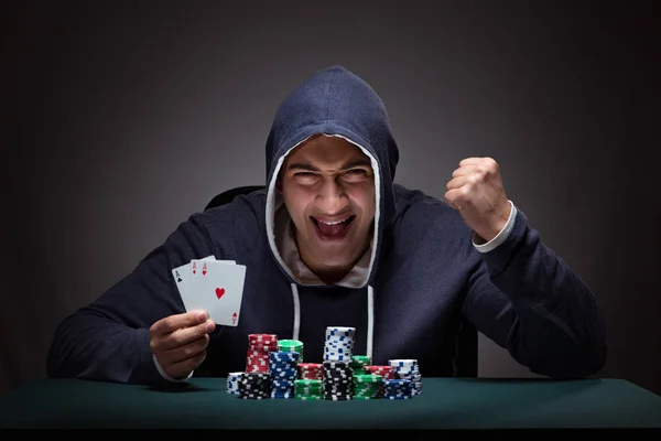 Young man wearing a hoodie with cards and chips gambling — Stock Photo, Image