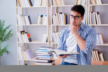 Kitapları olan genç bir öğrenci sınavlara hazırlanıyor.