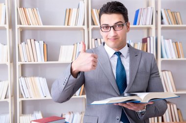 Büyüteçle hukuk fakültesi öğrencisi kitap okuyor.