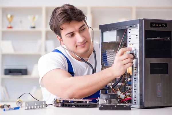 Computer repairman repairing desktop computer