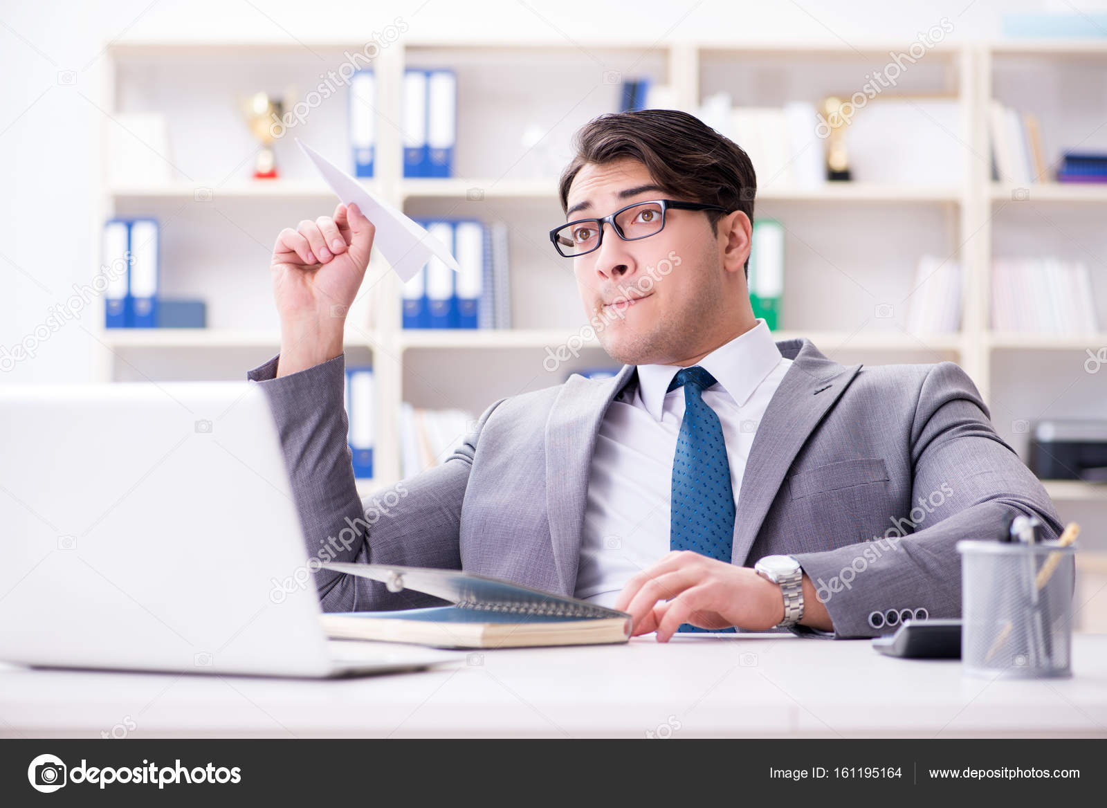 Businessman With Paper Airplane In Office Stock Photo