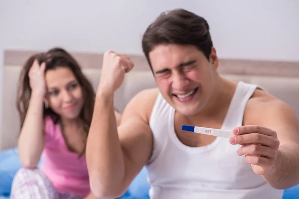 Young family with pregnancy test results — Stock Photo, Image