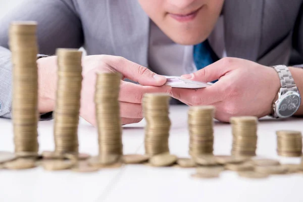 Businessman with golden coins in business growth concept — Stock Photo, Image