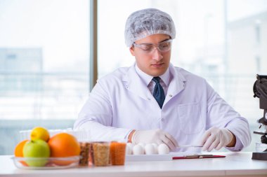 Besin uzmanı gıda ürünlerini laboratuarda test ediyor.