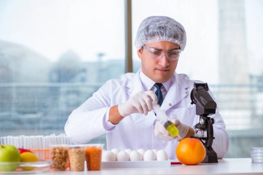 Besin uzmanı gıda ürünlerini laboratuarda test ediyor.