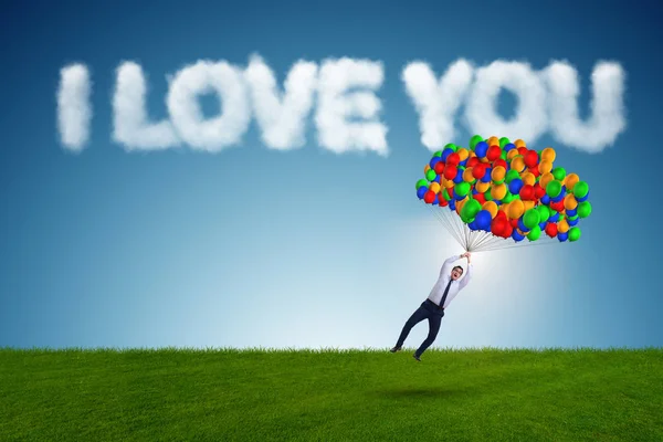Человек летит на воздушных шарах в романтической концепции — стоковое фото