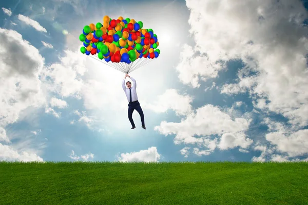 Empresário voando balões no dia brilhante — Fotografia de Stock