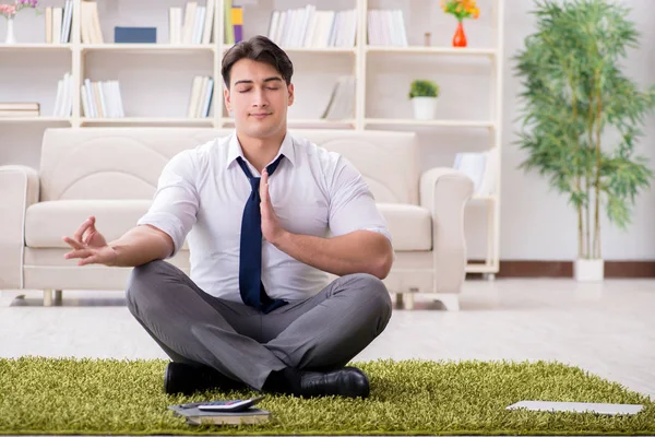 Businessman sitting on the floor in office — Stock Photo, Image