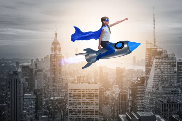 Little girl flying rocket in superhero concept — Stock Photo, Image