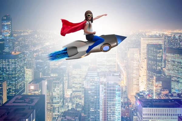 Little girl flying rocket in superhero concept — Stock Photo, Image