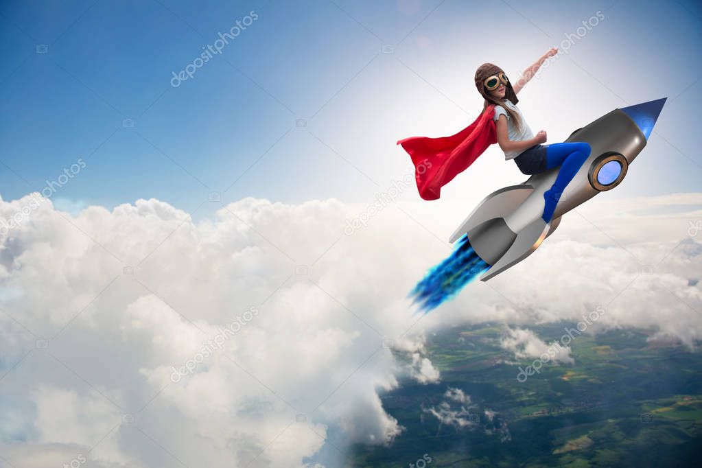 Little girl flying rocket in superhero concept