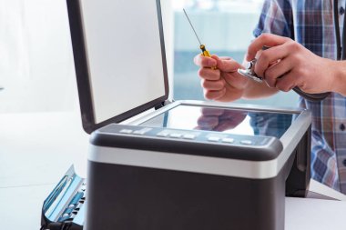 Tamirci bozuk renk yazıcısını tamir ediyor