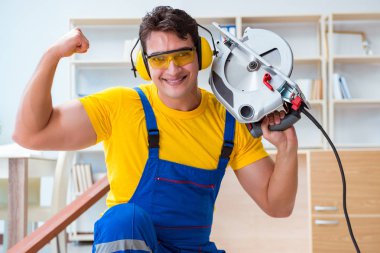 Tamirci marangoz. Dolaşım halindeki tahta testereyi kesiyor.