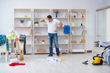 Adam evi temizliyor.