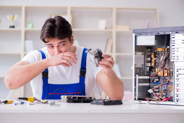 Computer repairman repairing desktop computer