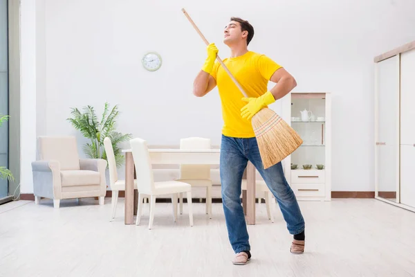 Jovem fazendo tarefas em casa — Fotografia de Stock