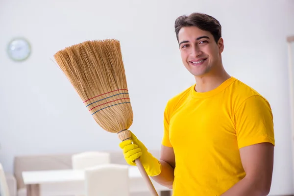 Young man doing chores at home — Stock Photo, Image