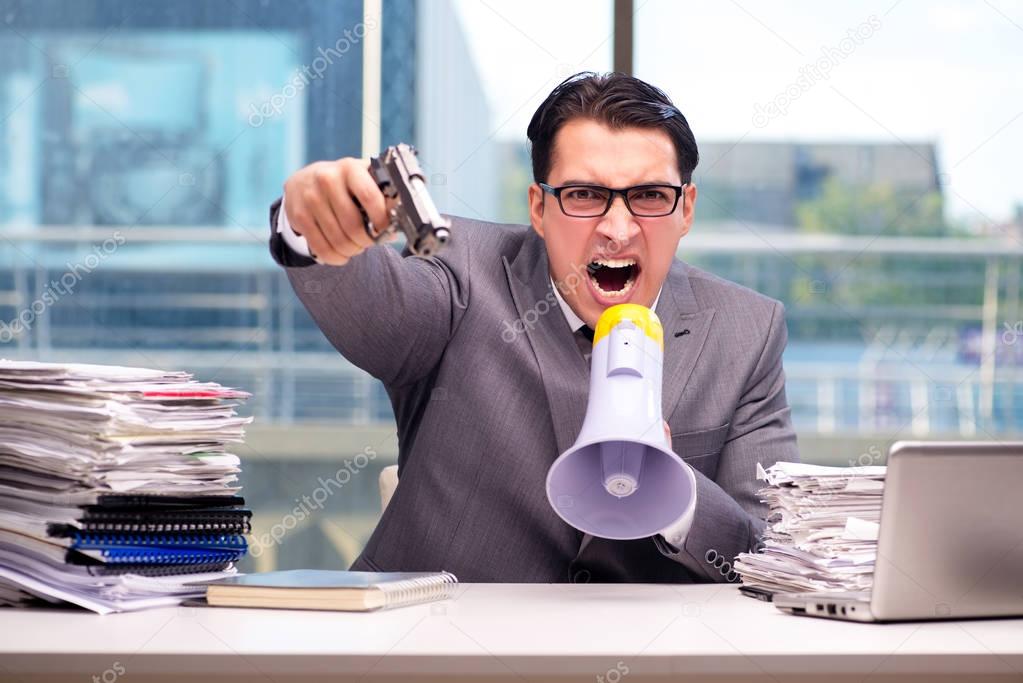 Angry businessman with gun in the office