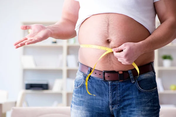 Man suffering from extra weight in diet concept — Stock Photo, Image