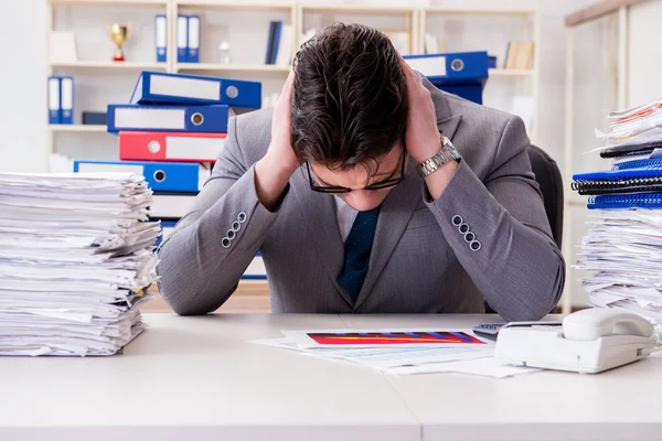 Businessman busy with much paperwork