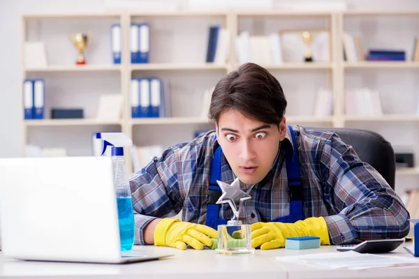 Male cleaner working in the office