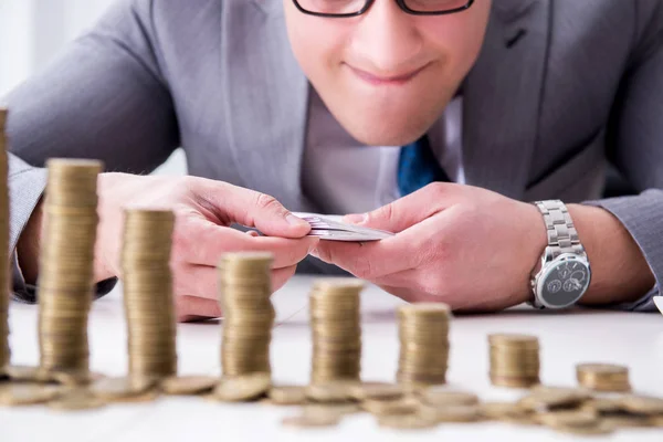 Businessman with golden coins in business growth concept — Stock Photo, Image