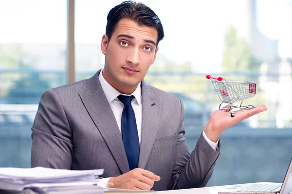 Businessman with shopping cart in office — Stock Photo, Image