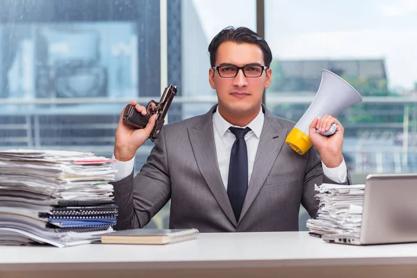 Angry businessman with gun in the office