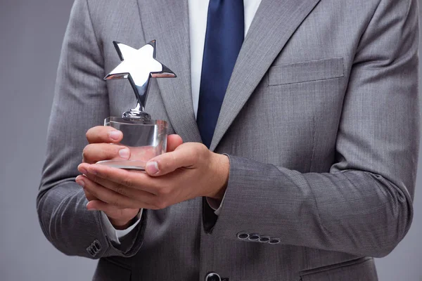 Businessman holding star award in business concept — Stock Photo, Image