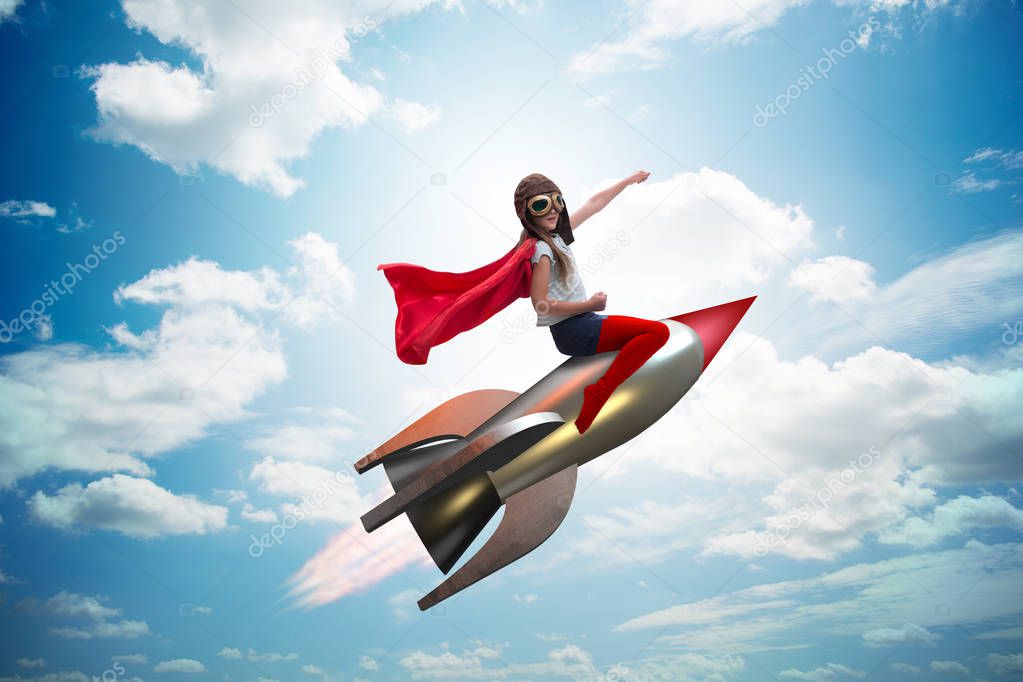 Little girl flying rocket in superhero concept