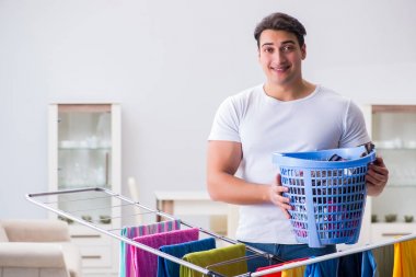 Man doing laundry at home clipart