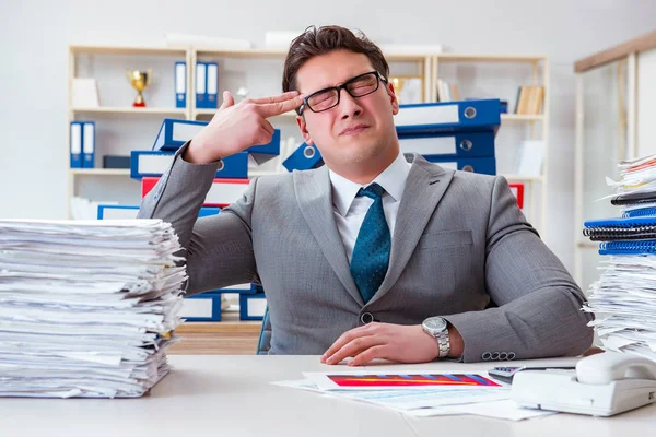 Businessman busy with much paperwork