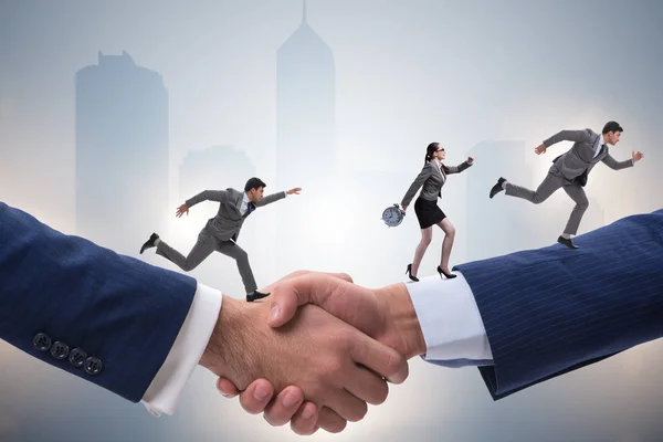 Cooperation concept with people running on handshake — Stock Photo, Image