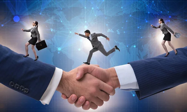 Cooperation concept with people running on handshake — Stock Photo, Image