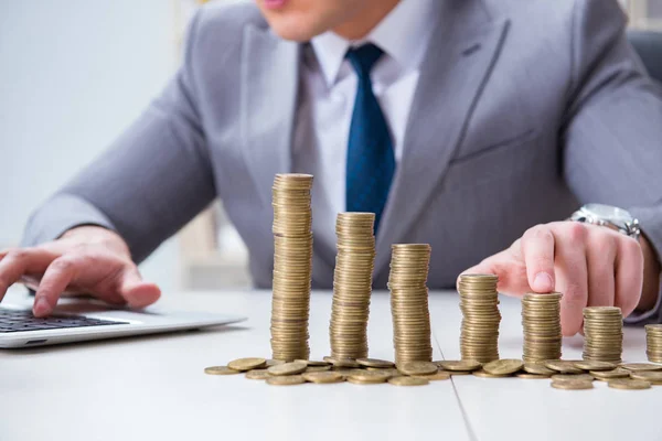 Businessman with golden coins in business growth concept — Stock Photo, Image