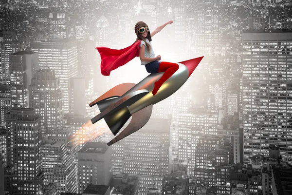 Little girl flying rocket in superhero concept — Stock Photo, Image