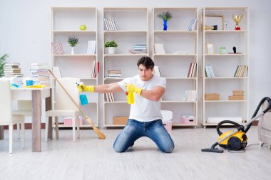 Adam evi temizliyor.