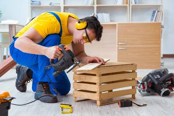Reparador carpintero cortando aserrar una tabla de madera con un electr — Foto de Stock